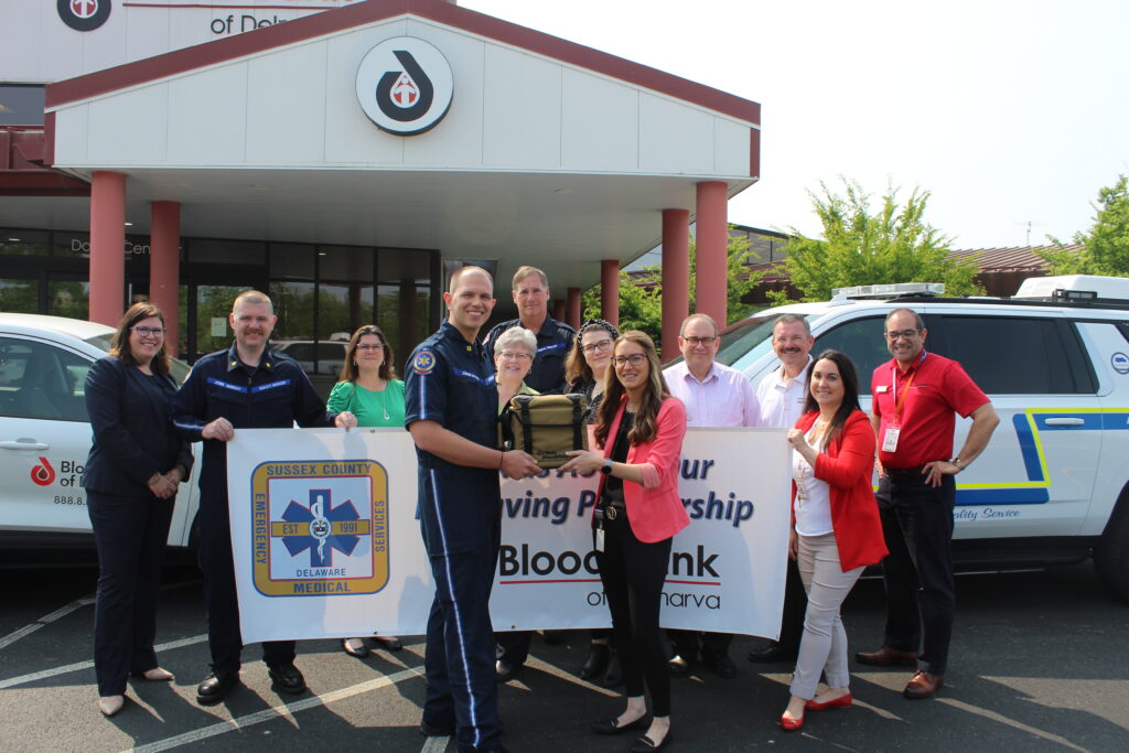 Director of Laboratories Kristin Frederick hands a cooler of whole blood to Sussex County EMS Training Coordinator Jordan Dattoli.
