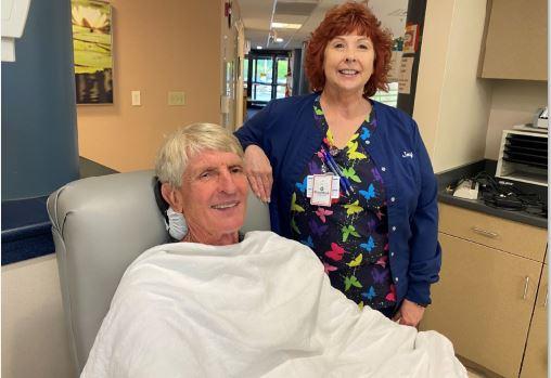 BBD's Joy Delucia standing with blood donor in donation chair.