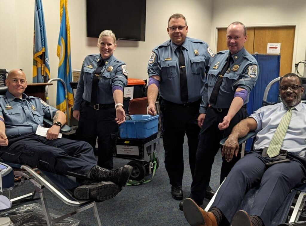 Five Firefighters smiling and donating blood 
