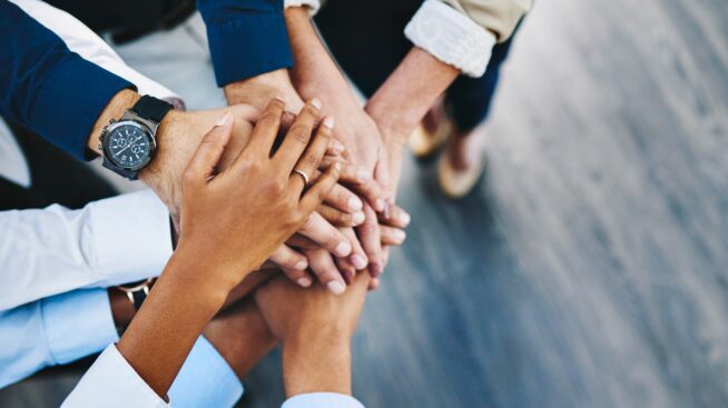 Leadership image with hands stacked in teamwork